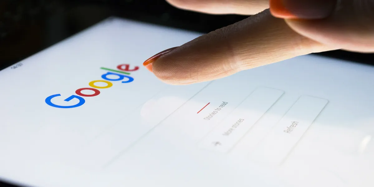Sankt-Petersburg, Russia, November 8, 2017: A woman's hand is touching screen on tablet computer iPad Pro at night for searching on Google search engine. Google is the most popular Internet search engine in the world.